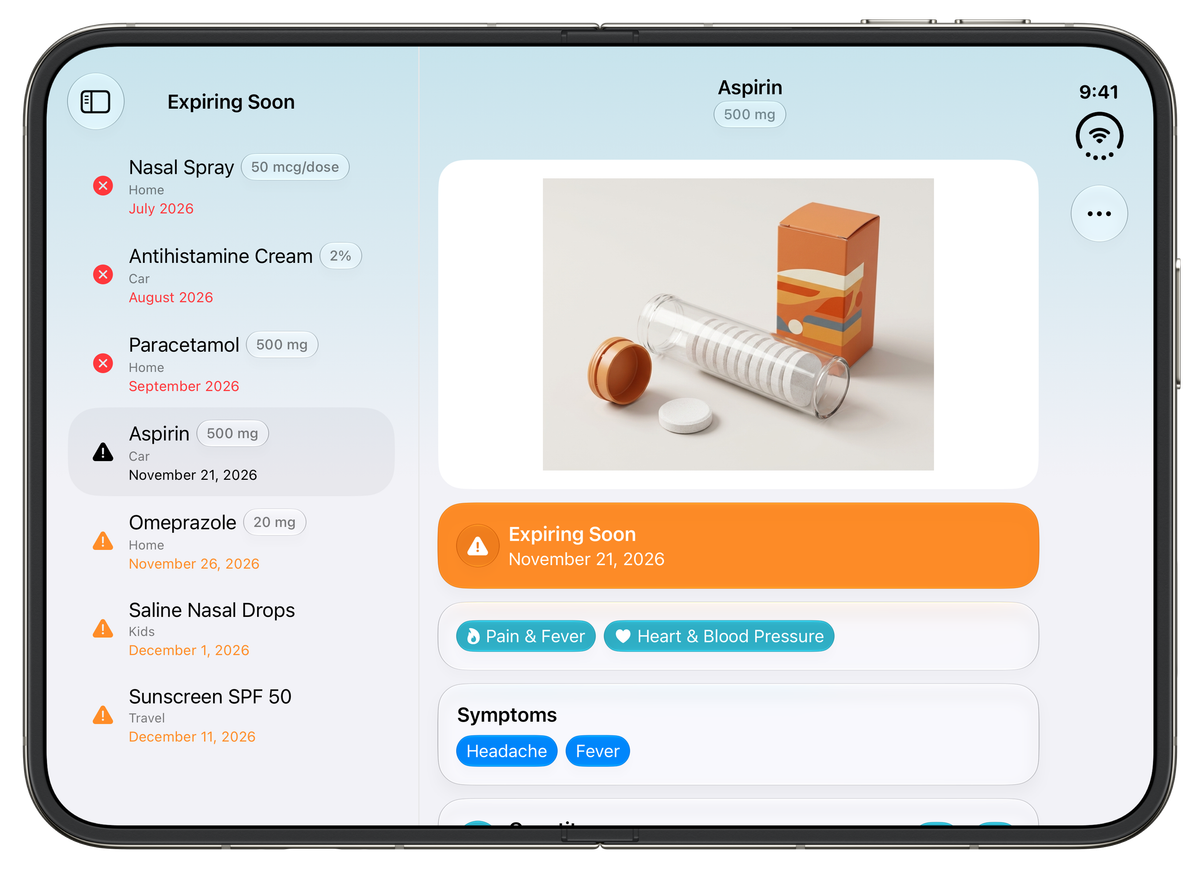 MyAidKit on an unfolded iPhone Duo in landscape. On the left, the Expiring Soon list shows medicines with warning icons and dates, with Aspirin 500 mg selected. On the right, the Aspirin details show its photo, an orange "Expiring Soon – November 21, 2026" banner, the "Pain & Fever" and "Heart & Blood Pressure" categories and the symptoms Headache and Fever.